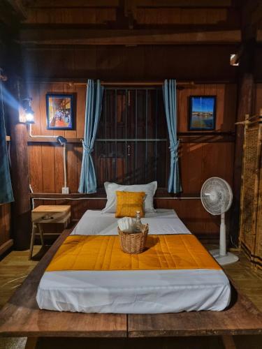 a bedroom with a large bed with a basket on it at Discover Kratie Homesetay in Kratie