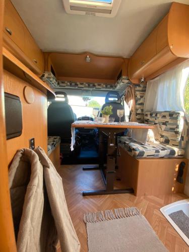 an interior view of an rv with a desk in it at The Happy Glamper in Viana do Castelo