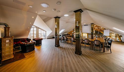 a large room with a bar and chairs at Royal Horse Resort in Balkasodis