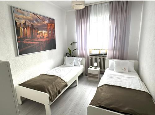 a bedroom with two beds and a window at Refugium 2020 in Marienheide