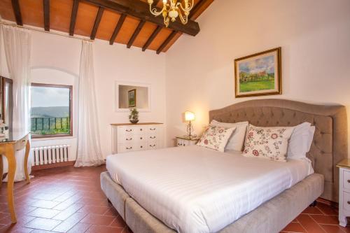 a bedroom with a large bed and a window at Florence Country Residence in Vaglia