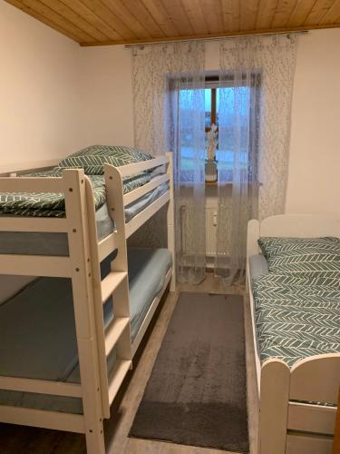 a room with two bunk beds and a window at Ferienwohnung Geyersberg 704 in Hauzenberg