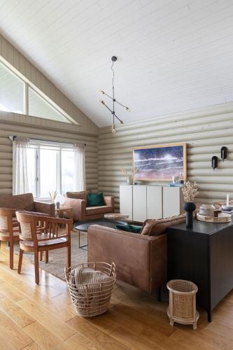 a living room with a couch and a table at The Eyrie - Luxurious Cabin in the Golden Circle in Úthlid