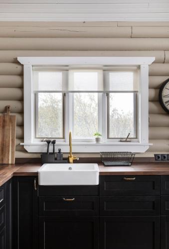 a kitchen with a sink and a window at The Eyrie - Luxurious Cabin in the Golden Circle in Úthlid
