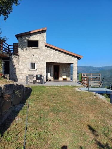a brick house with a large yard in front of it at Casa da raposeira in Louredo