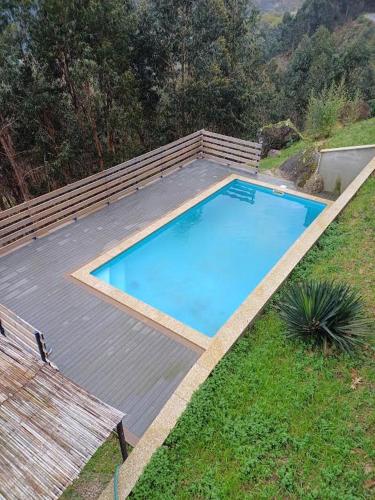 an overhead view of a swimming pool on a wooden deck at Casa da raposeira in Louredo