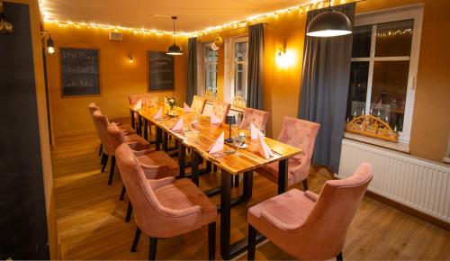 a dining room with a long table and chairs at Berghotel Drei Brüder Höhe in Marienberg