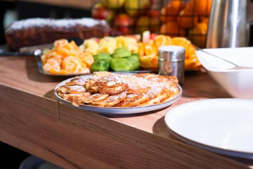 a table topped with a plate of food on a table at Berghotel Drei Brüder Höhe in Marienberg