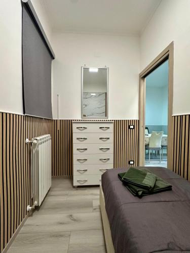 a bedroom with a bed and a dresser and a mirror at Casa Alma in Naples