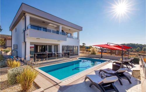 a villa with a swimming pool and a house at Cozy Home In Punat With Sauna in Punat