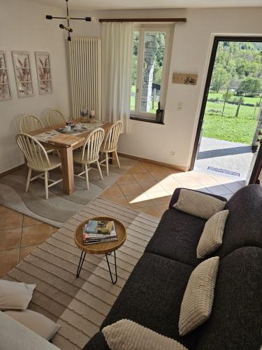 a living room with a couch and a table at Casa Sonia Your Refuge in Valle Verzasca in Frasco