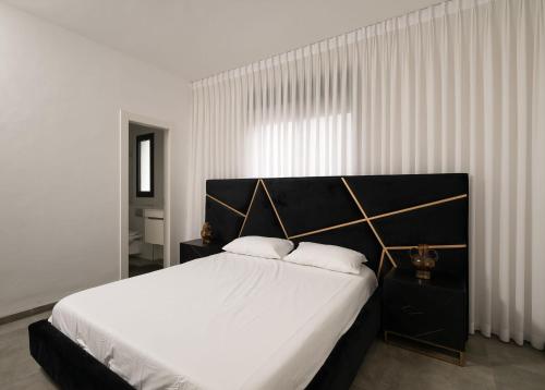 a bedroom with a large bed with white sheets at Stunning and spacious in Kiryat Ata in Qiryat Ata