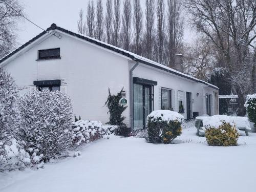 a white house with snow on the front of it at Mary's Poppies - Bed & Breakfast in Blandain