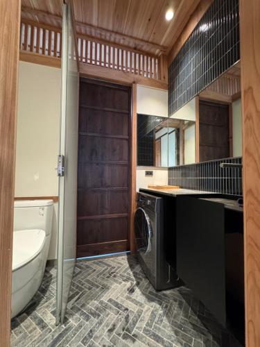 a bathroom with a sink and a washing machine at 弎秋 A chu in Chiayi City