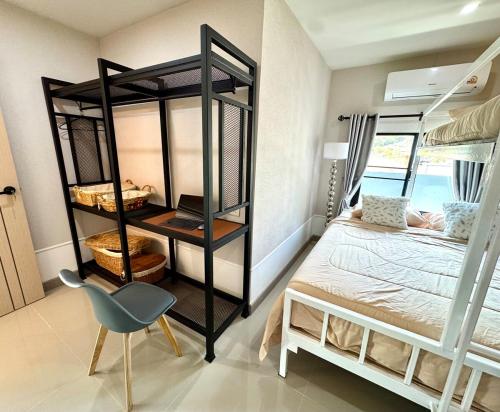 a bedroom with a bunk bed and a desk and a chair at Check it Near Panyaden,SBS,Kad Farang,13min to airport in Hang Dong