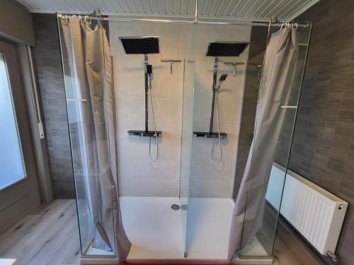 a shower with a glass enclosure in a bathroom at Mary's Poppies - Bed & Breakfast in Blandain