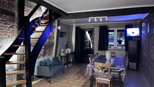 a dining room with a table and chairs and a staircase at Chez Béné in Rochefort