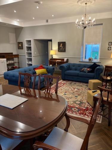a living room with a table and a blue couch at The Blue Door in Castleisland