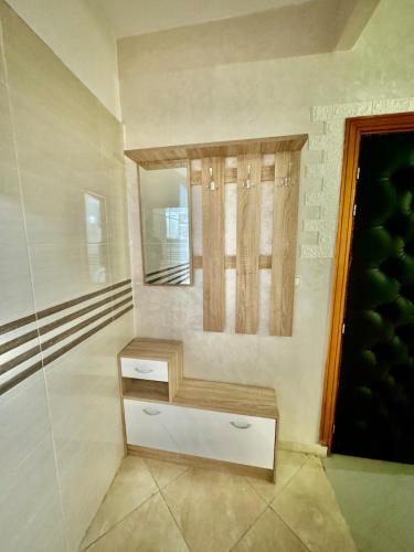 a bathroom with a bench and a window at Apartment, well equipped in Fez