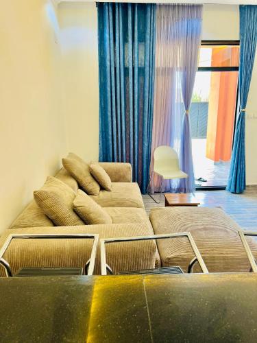 a living room with a bed and a couch at Dash apartment No 1 - Quartier miroir in Bujumbura
