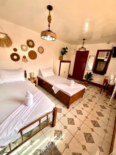 a bedroom with two beds in a room at Maliag Studio Type Room for Rent in Coron