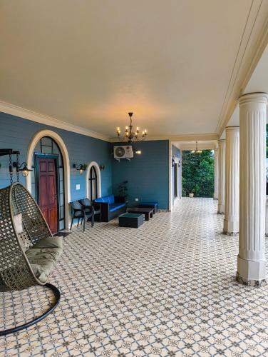 a living room with blue walls and a couch at Villa Forever Coorg in Madikeri