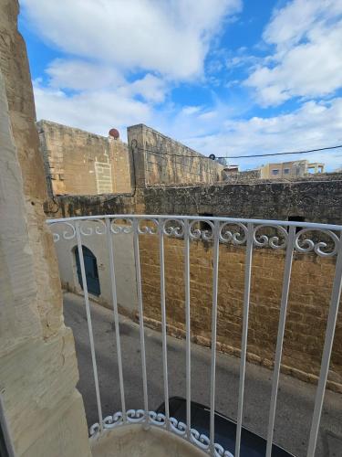 a view from the balcony of a building with a fence at Studio in a Charming Maltese town house in Qrendi