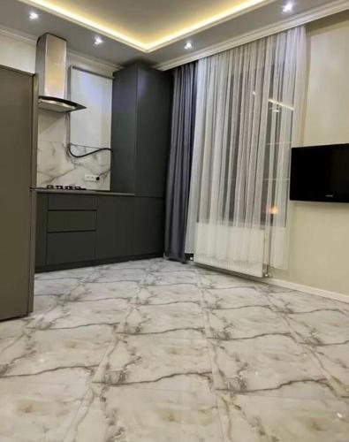 a living room with a marble floor and a window at Центр Гюмри in Gyumri
