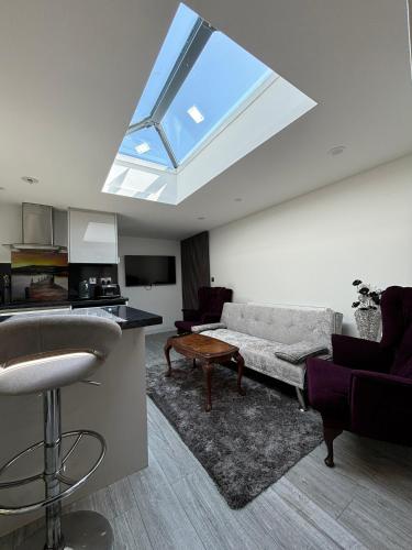 a living room with a couch and a window at Exquisite 2 Bedroom Fully Furnished Annex in Bradenham