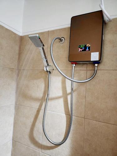 a shower with a hose on the floor at Twilight25 Condo in Cebu City