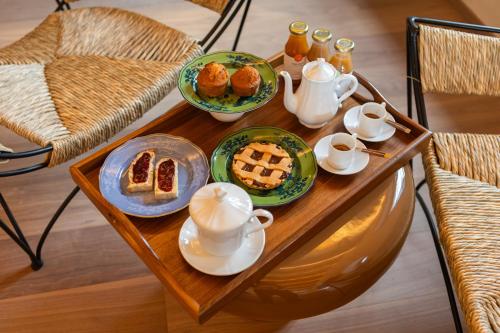 a table with plates of food and tea on it at Hidden Dalla Gioconda in Gabicce Mare