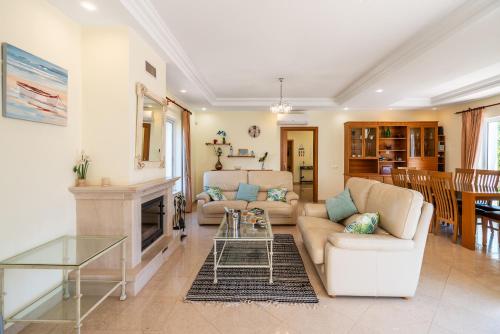 a living room with a couch and a fireplace at Captivating Villa 600M to Vau Beach in Vau