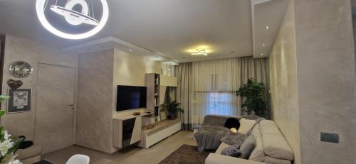 a living room with a couch and a tv at Maison Sofia in Aosta