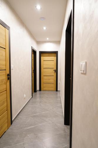 a hallway with two doors and a tile floor at Apartamenty pod Dębami - noclegi Beskid Niski in Odrzechowa
