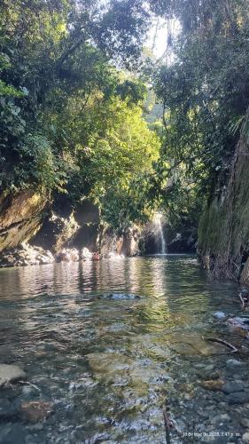 a river with a waterfall in the middle of it at Glamping Verde Melcocho in San Francisco