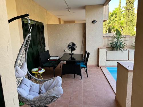 a patio with a hammock and a table and chairs at Oasis Paradise 4A in Corverica
