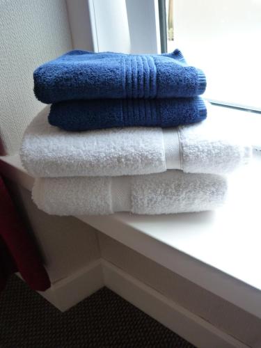 a pile of towels sitting on a window sill at Wee Ness Cottage in Inverness