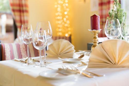 a table with wine glasses on a white table cloth at Bergresort Seefeld in Seefeld in Tirol