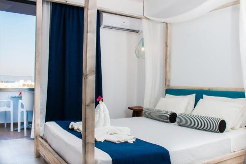 a bedroom with two beds and a balcony at Malibu Boutique Studios & Bungalows in Faliraki