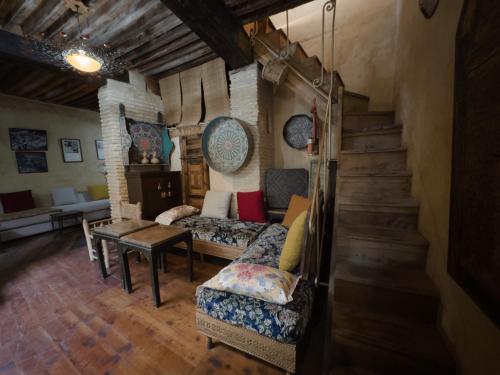 a living room with a couch and a staircase at Museum House - Dar Melyani in Fez