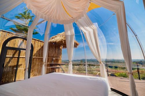 a bed in a room with a view at PARACH RESORT KHAOKHo in Khao Kho