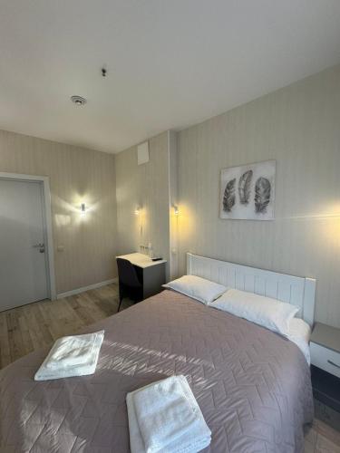 a bedroom with a large bed and a desk at Готель Elisavetgrad in Kropyvnytskyi