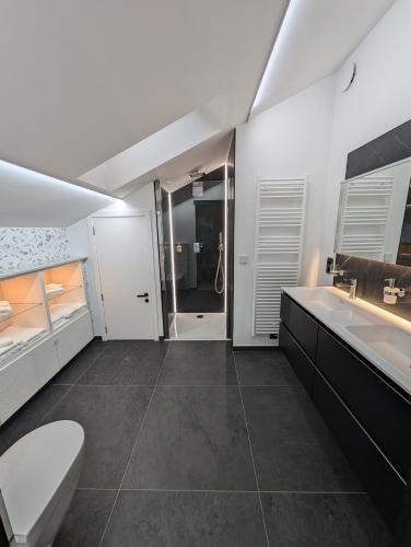 a bathroom with a toilet and a sink and a tub at Francorchamps studio 8 in Stavelot