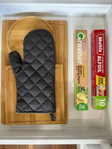 a drawer in a refrigerator with a black pillow at Modern quiet two bedroom apt in Canberra City in Canberra