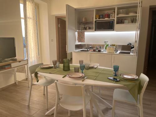 a kitchen with a table and chairs in a kitchen at La casa nel Monferrato "LA CONTENTËSSA" in Asti