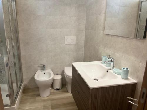 a bathroom with a sink and a toilet at La casa nel Monferrato "LA CONTENTËSSA" in Asti