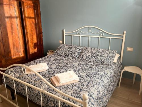 a bedroom with a bed with a metal frame at La casa nel Monferrato "LA CONTENTËSSA" in Asti