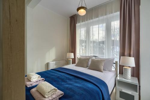 Ένα ή περισσότερα κρεβάτια σε δωμάτιο στο TAPO Apartamenty