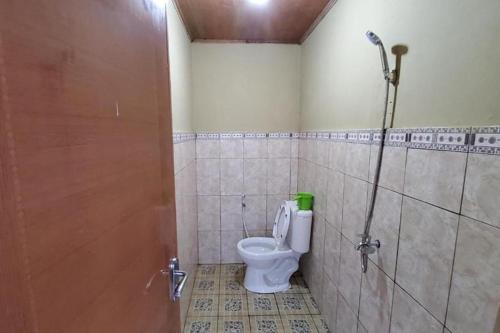 a bathroom with a toilet and a shower stall at Villa Zoya 1 in Bogor
