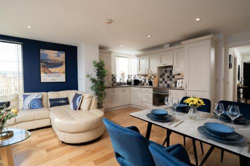a living room with a couch and a table at River Side Apartment, City Centre - Beautiful View and Free Parking! in Belfast